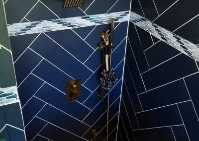 A beautiful blue, herring bone tiled shower